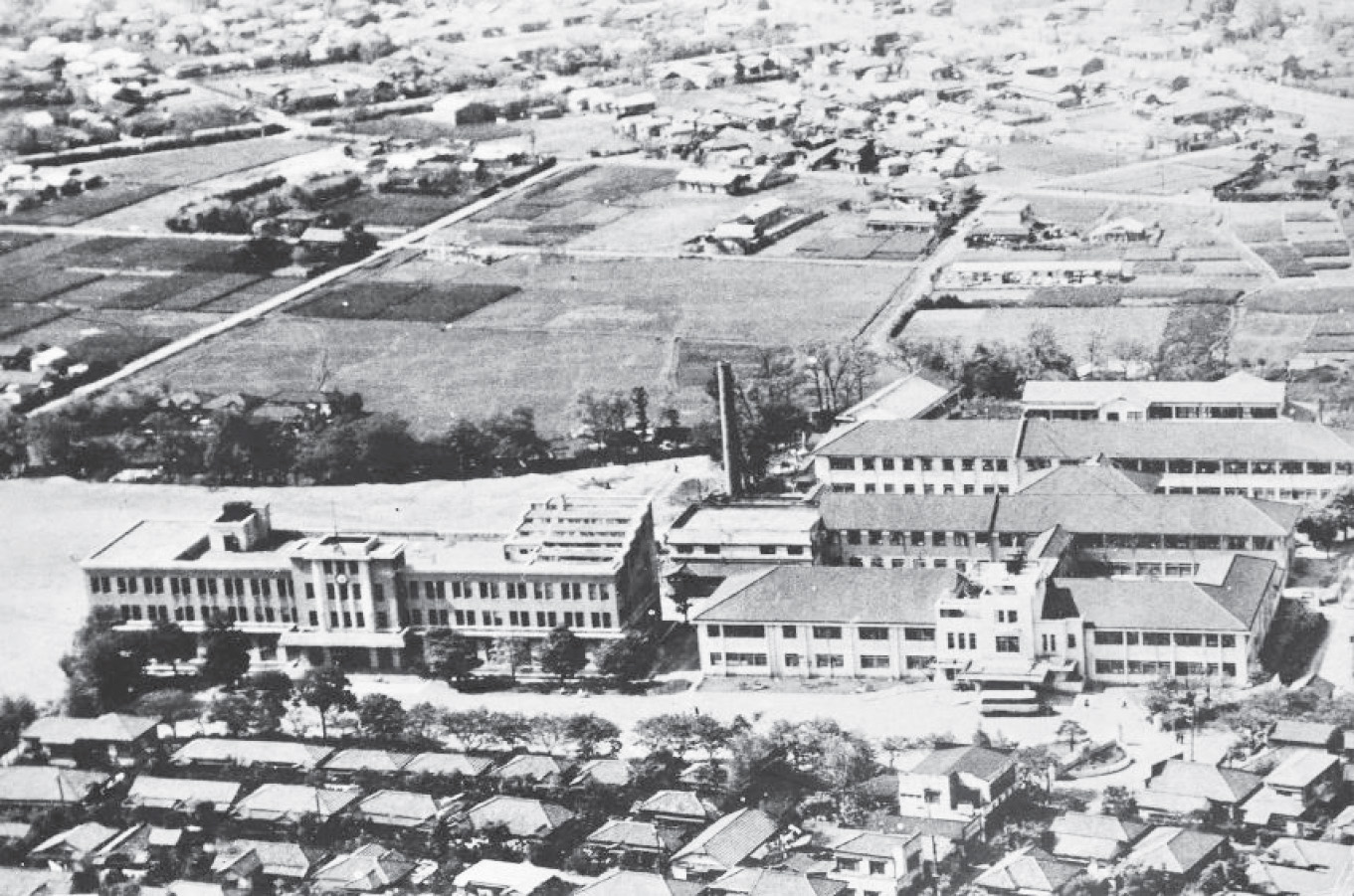 写真3:医学部と病院外来棟全景。<br>病院後方が第一病棟,その背後が第2病棟と思われる(27回生卒業アルバム「機上から」による)